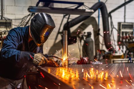 welder-welding-a-piece-of-metal-in-a-factory
